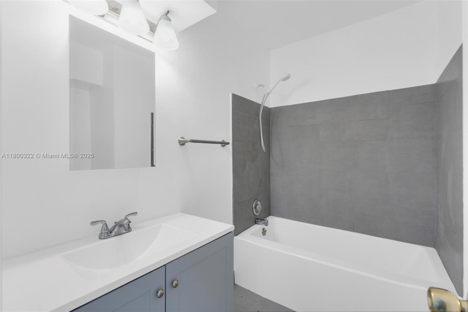 3051 Northwest 77th Street Miami, FL 33147 - Photo 38 of 44 a bathroom with a tub a sink and mirror