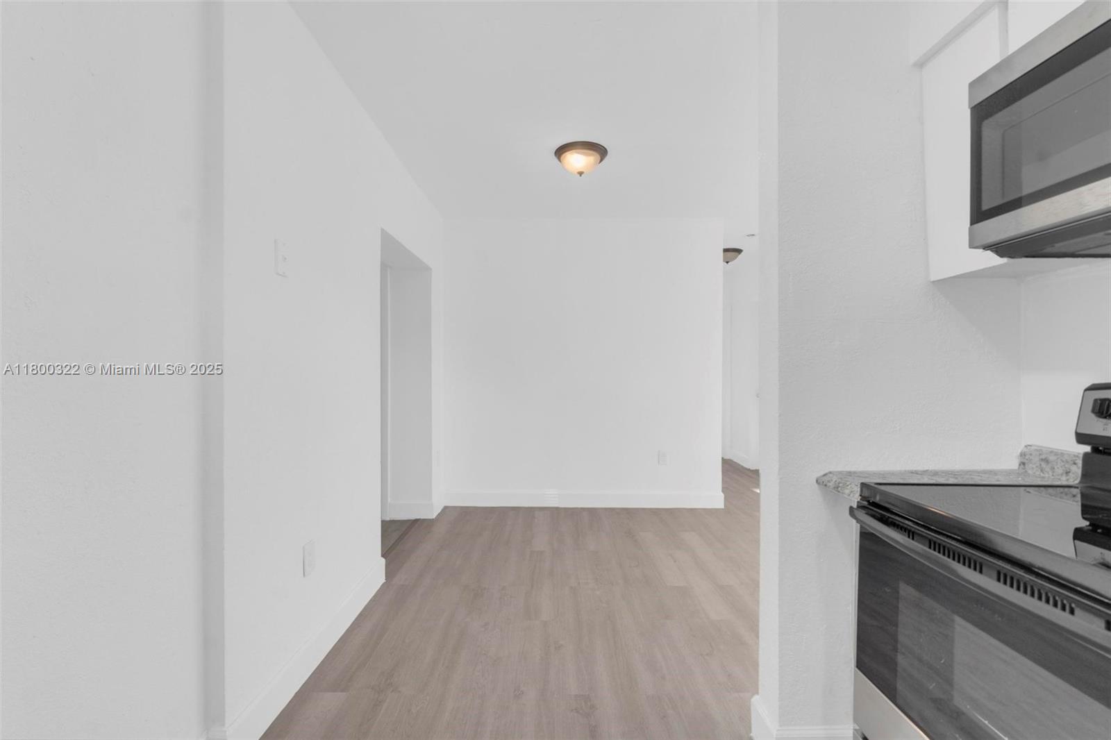 3051 Northwest 77th Street Miami, FL 33147 - Photo 43 of 44 a view of a kitchen with wooden floor and cabinets