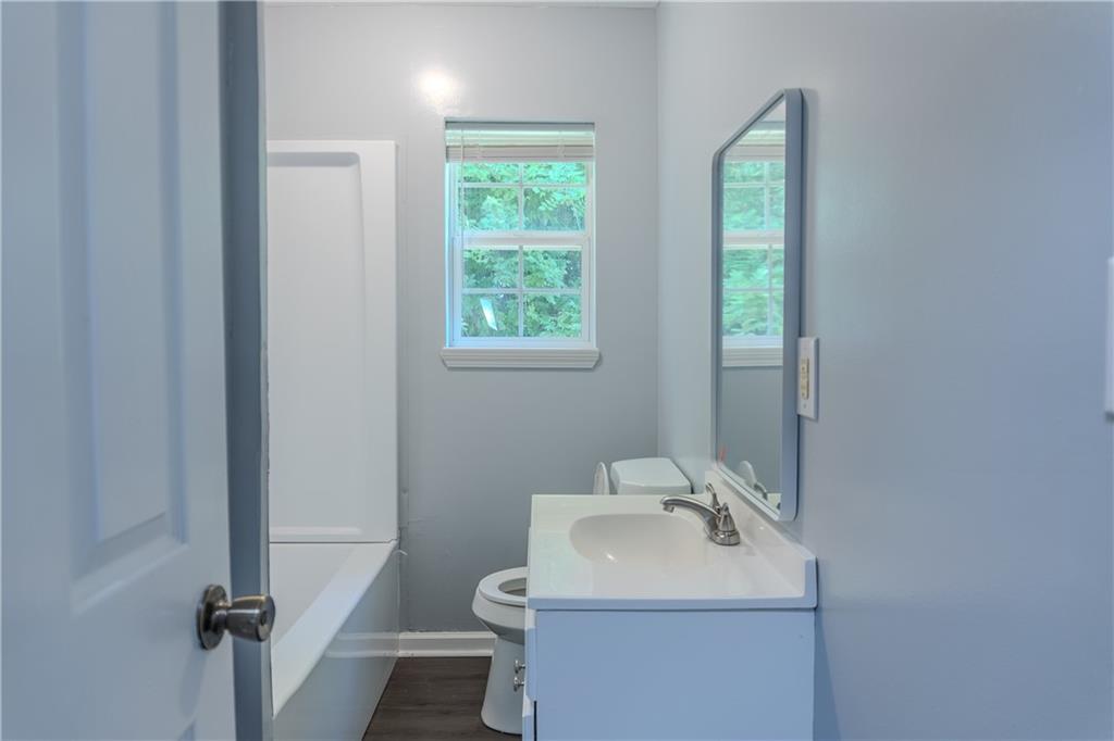 53 Washington Drive Forsyth, GA 31029 - Photo 10 of 19 a bathroom with a sink toilet and a mirror