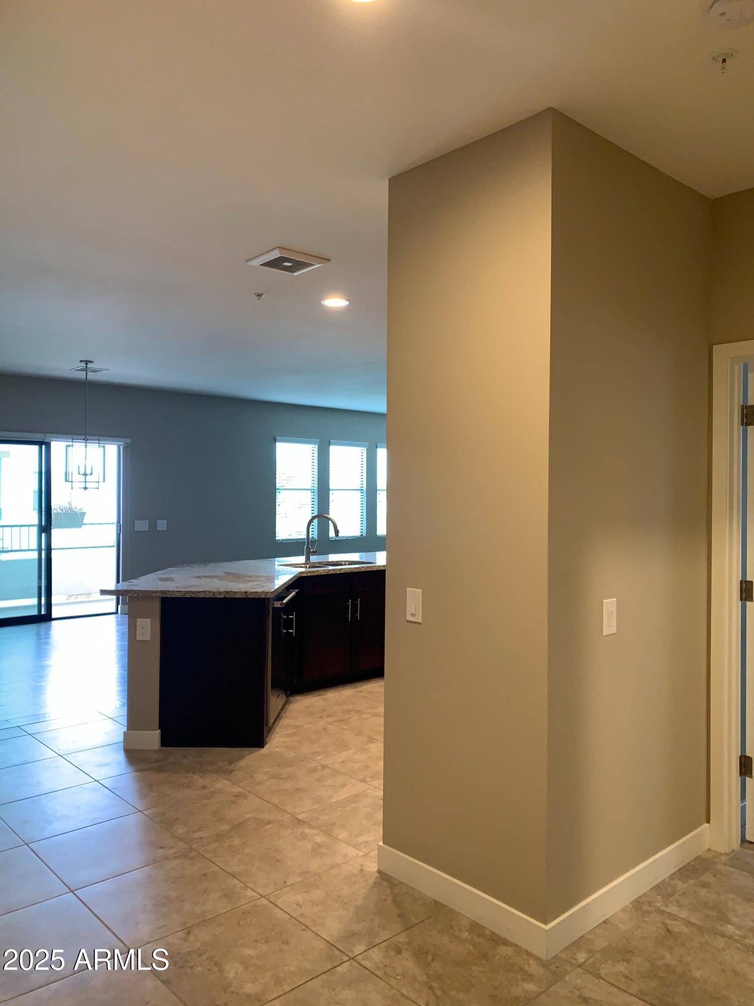 2511 West Queen Creek Road, Unit 326 Chandler, AZ 85248 - Photo 12 of 32 a large room with a window and a table in it