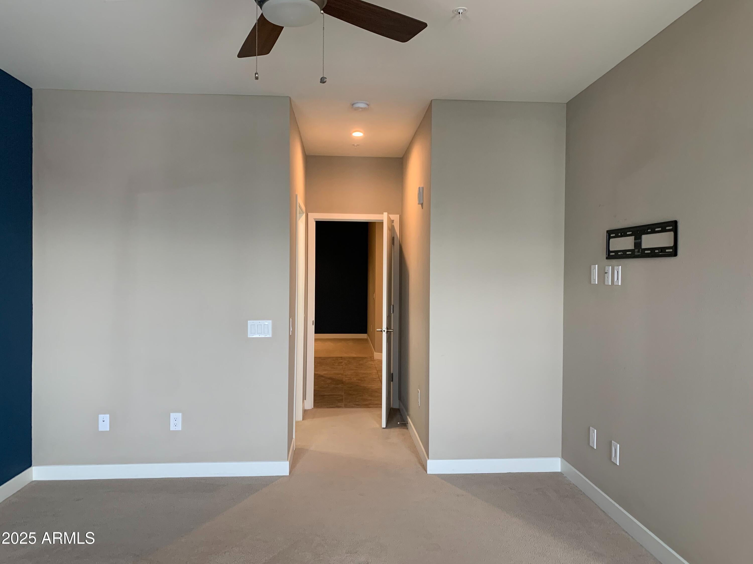 2511 West Queen Creek Road, Unit 326 Chandler, AZ 85248 - Photo 16 of 32 an empty room with closet and a chandelier fan