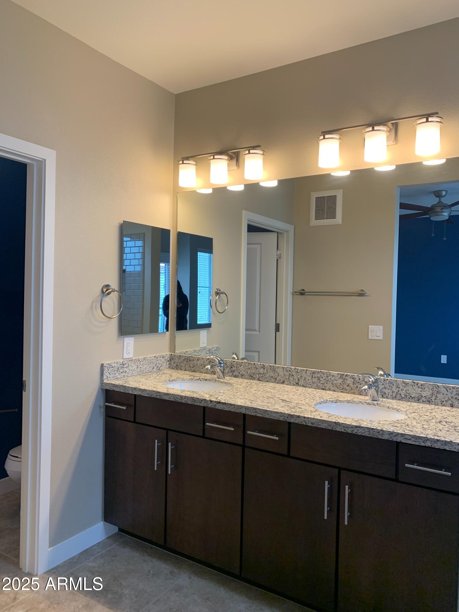 2511 West Queen Creek Road, Unit 326 Chandler, AZ 85248 - Photo 21 of 32 a bathroom with a granite countertop sink and a mirror
