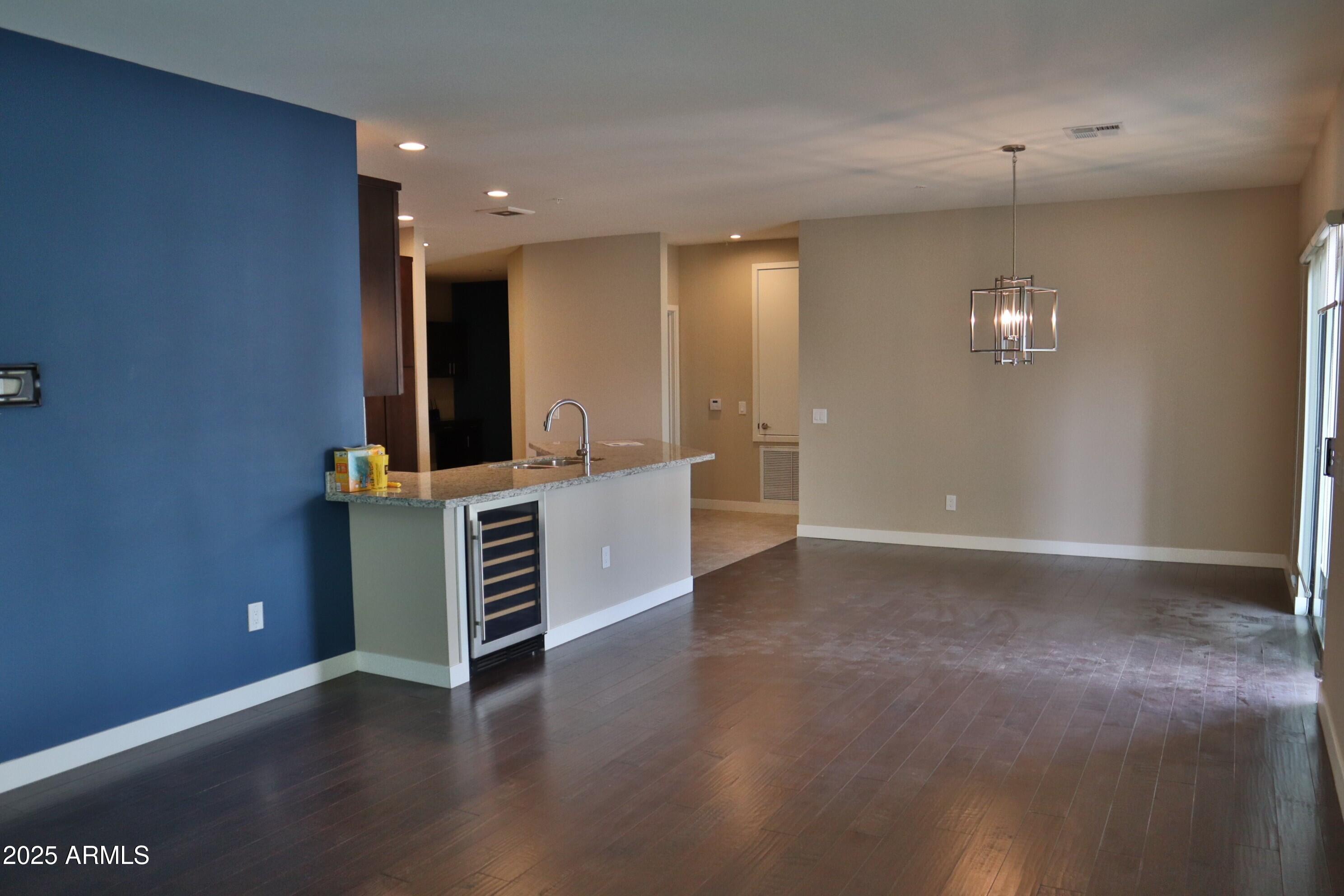 2511 West Queen Creek Road, Unit 326 Chandler, AZ 85248 - Photo 5 of 32 a view of cabinets and wooden floor