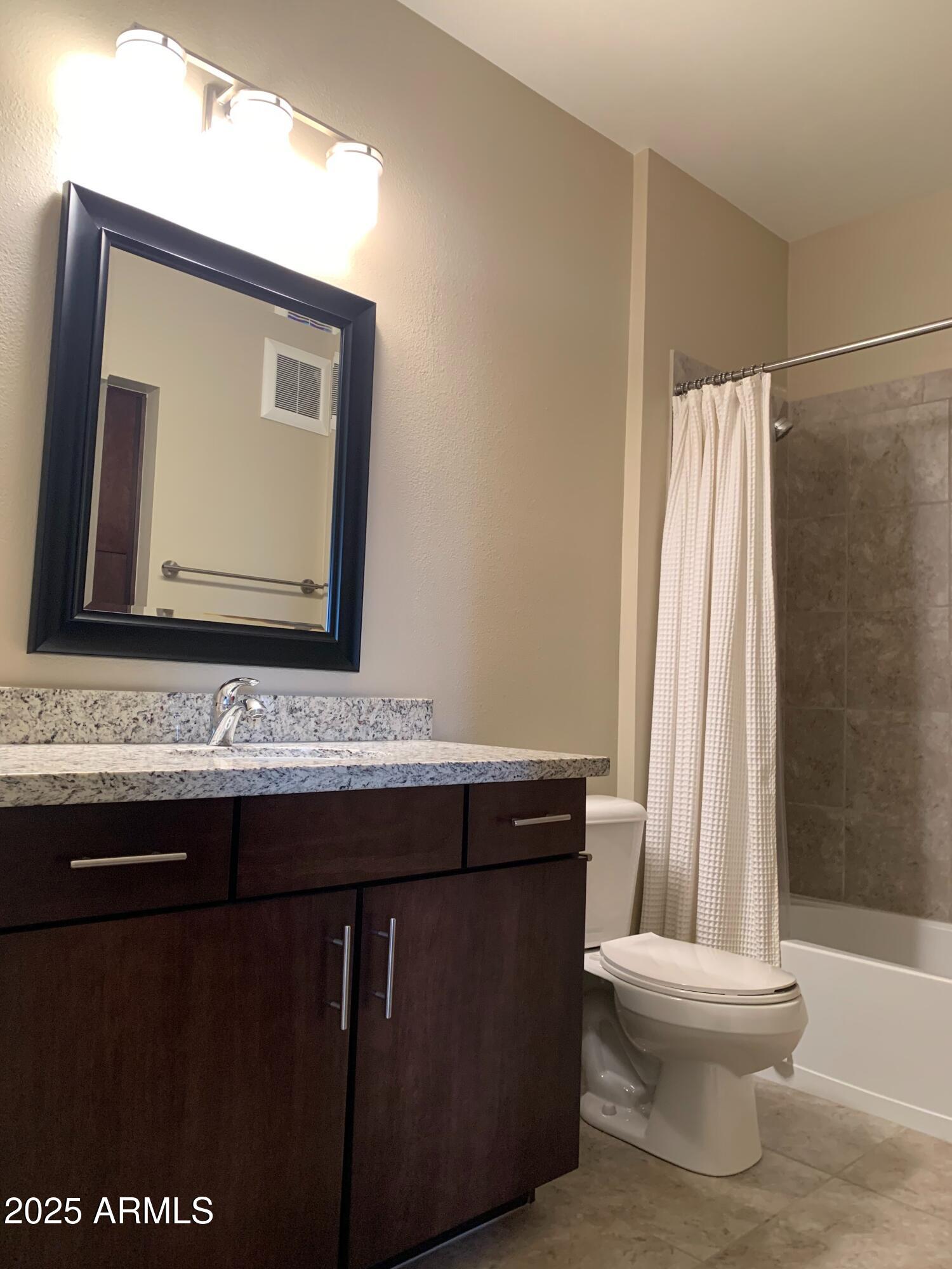 2511 West Queen Creek Road, Unit 326 Chandler, AZ 85248 - Photo 9 of 32 a bathroom with a sink and a mirror