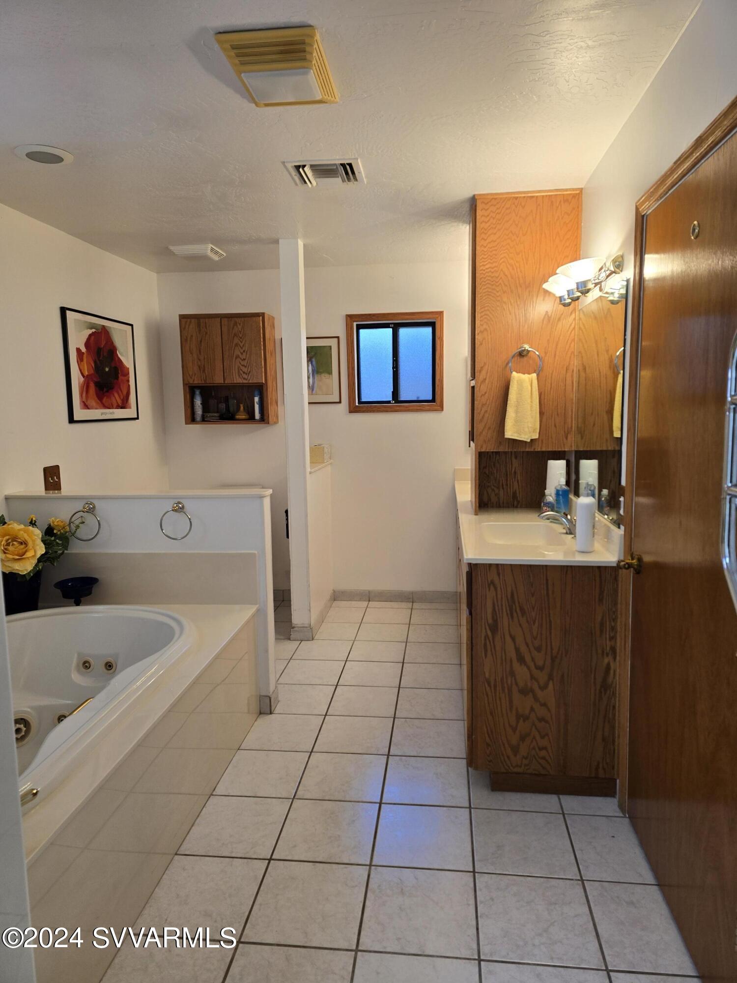 1707 Sawmill Road Cottonwood, AZ 86326 - Photo 27 of 93 a bathroom with a tub a sink and a mirror