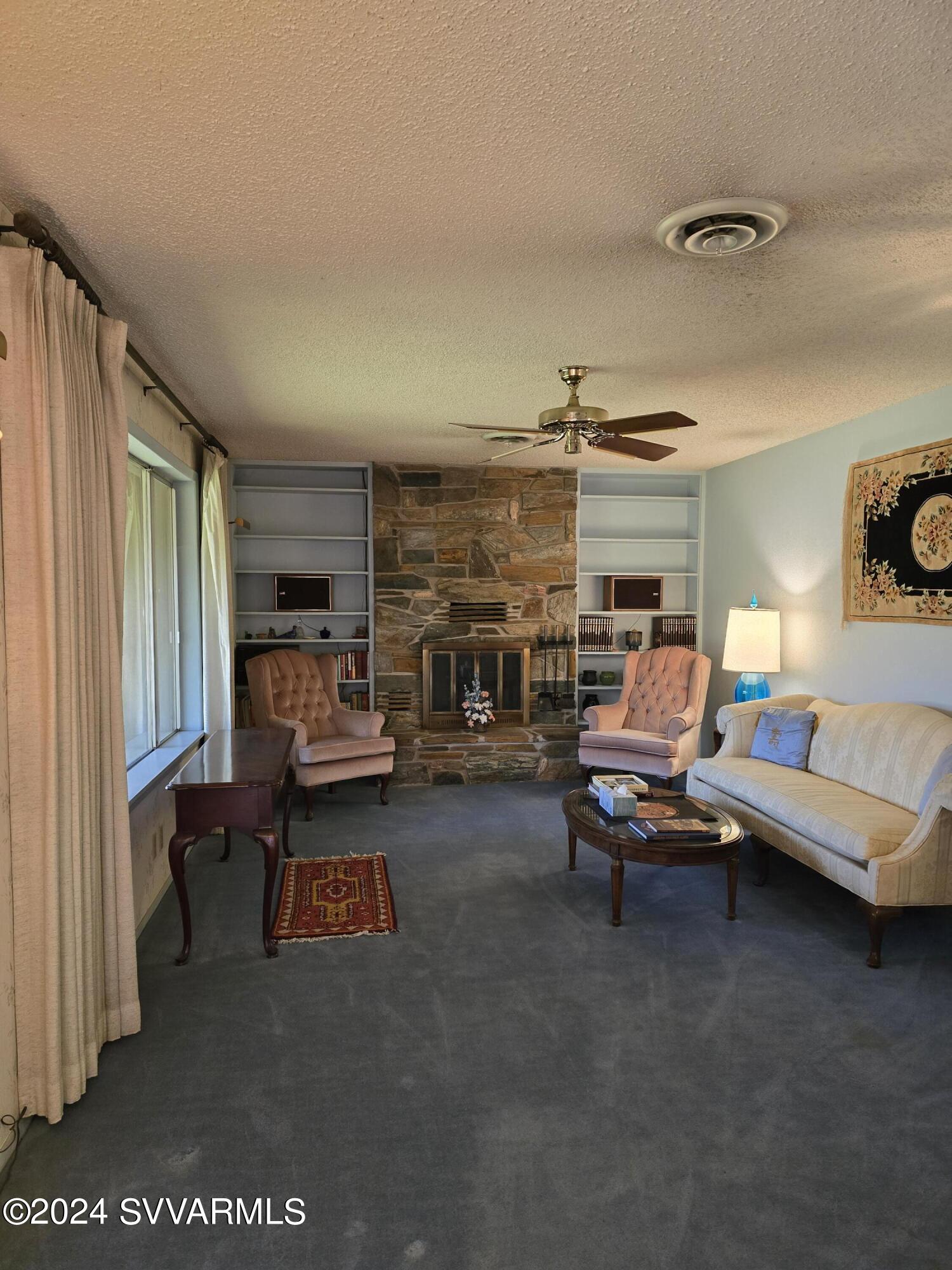 1707 Sawmill Road Cottonwood, AZ 86326 - Photo 38 of 93 a living room with furniture and a fireplace