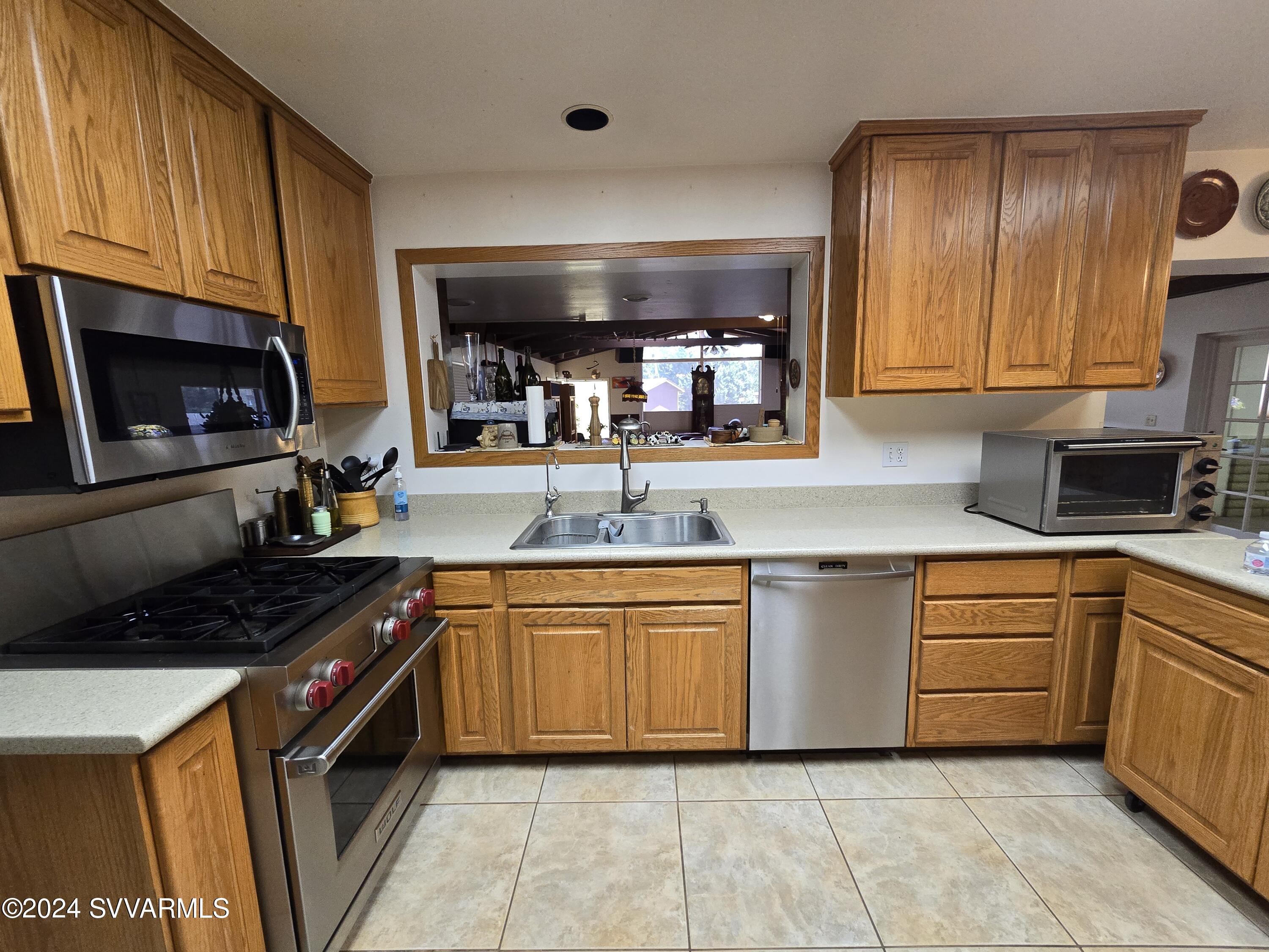 1707 Sawmill Road Cottonwood, AZ 86326 - Photo 40 of 93 a kitchen with granite countertop stainless steel appliances and cabinets