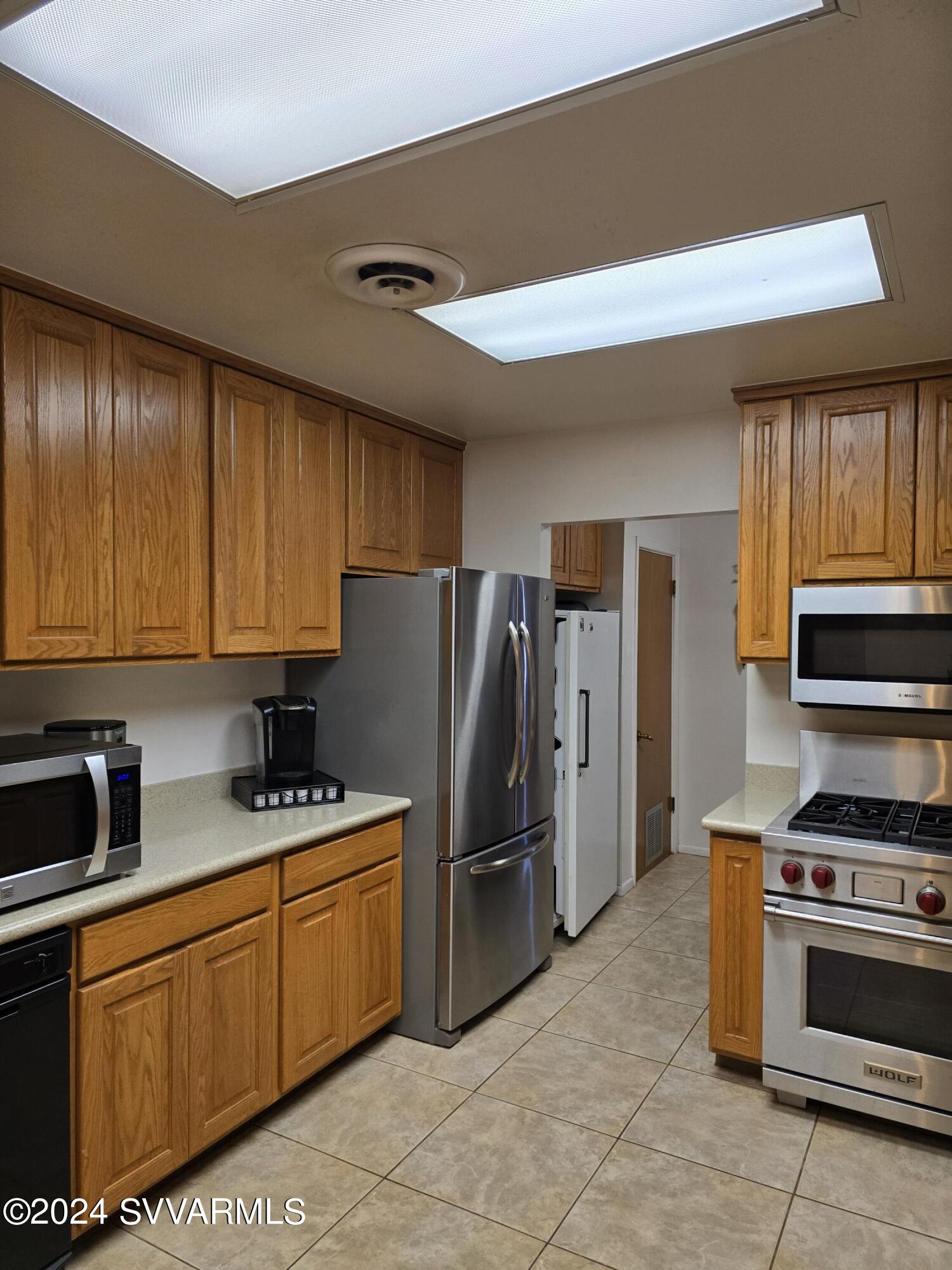 1707 Sawmill Road Cottonwood, AZ 86326 - Photo 46 of 93 a kitchen with stainless steel appliances granite countertop a stove refrigerator sink and cabinets