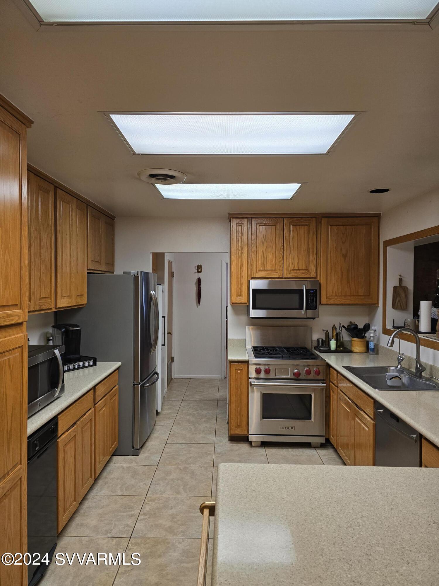 1707 Sawmill Road Cottonwood, AZ 86326 - Photo 47 of 93 a kitchen with stainless steel appliances a stove sink and refrigerator