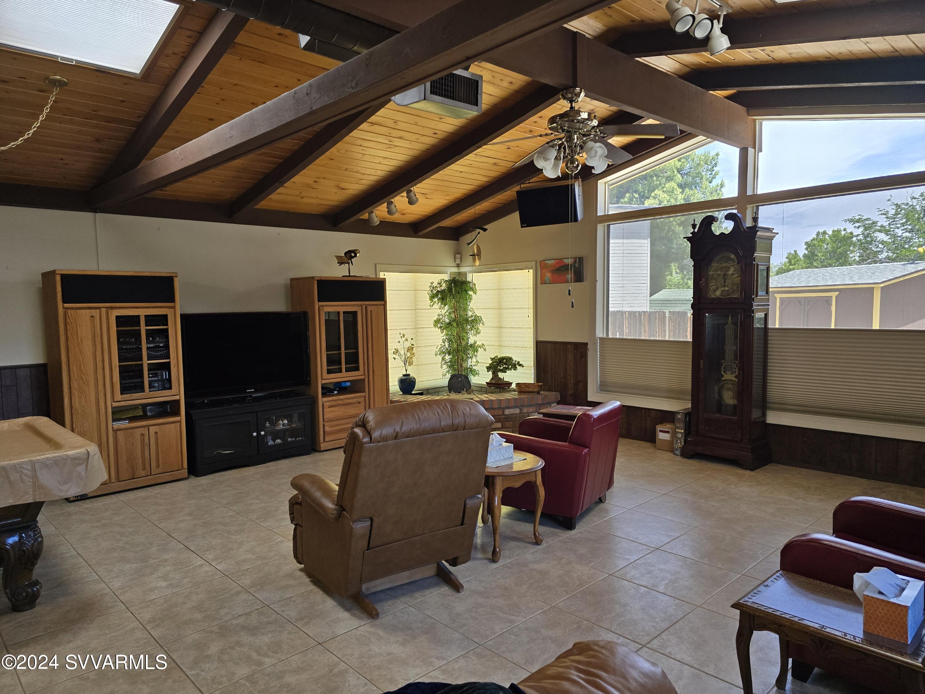 1707 Sawmill Road Cottonwood, AZ 86326 - Photo 53 of 93 a living room with furniture a flat screen tv and a large window