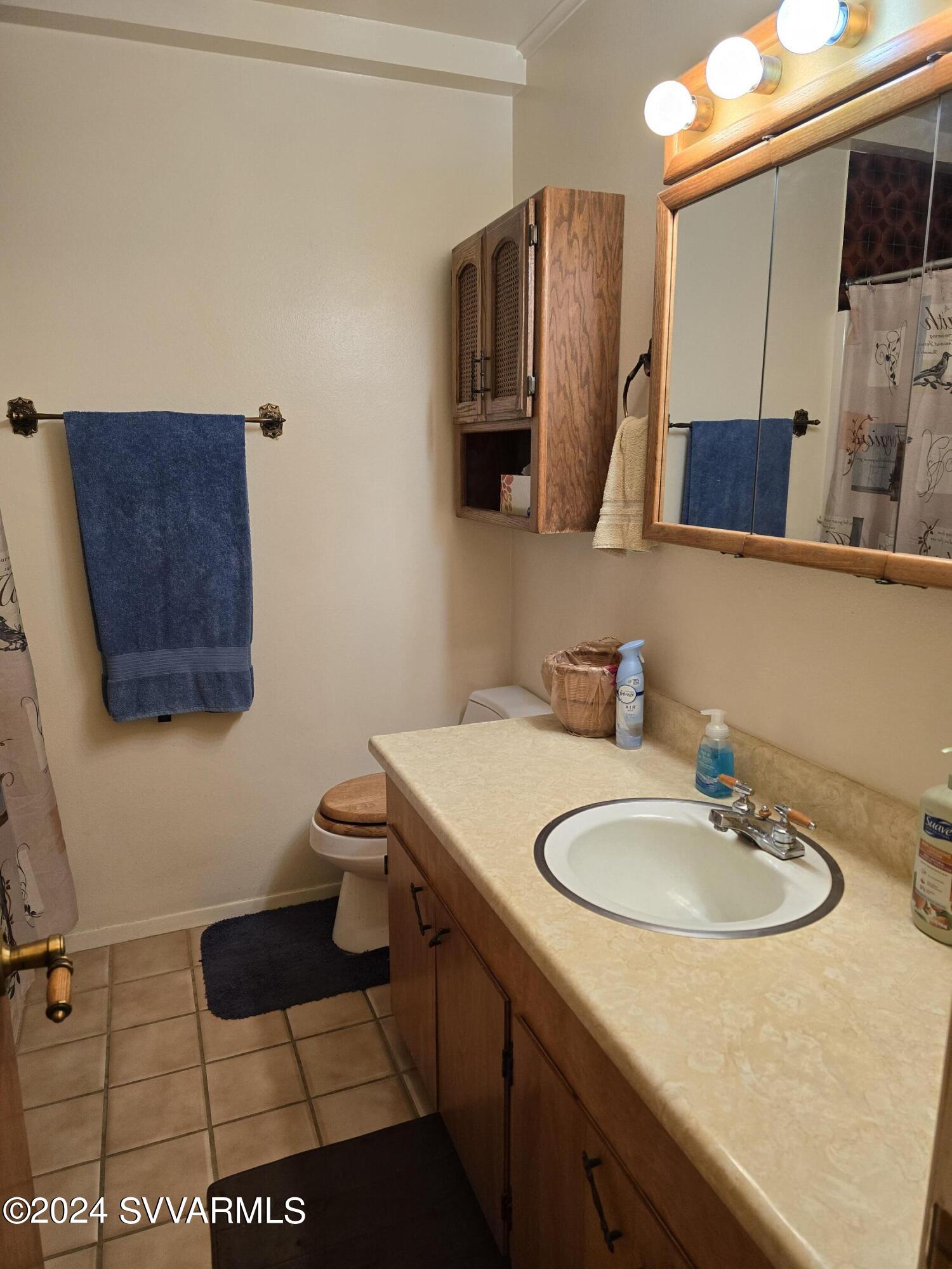 1707 Sawmill Road Cottonwood, AZ 86326 - Photo 58 of 93 a bathroom with a sink a toilet and mirror