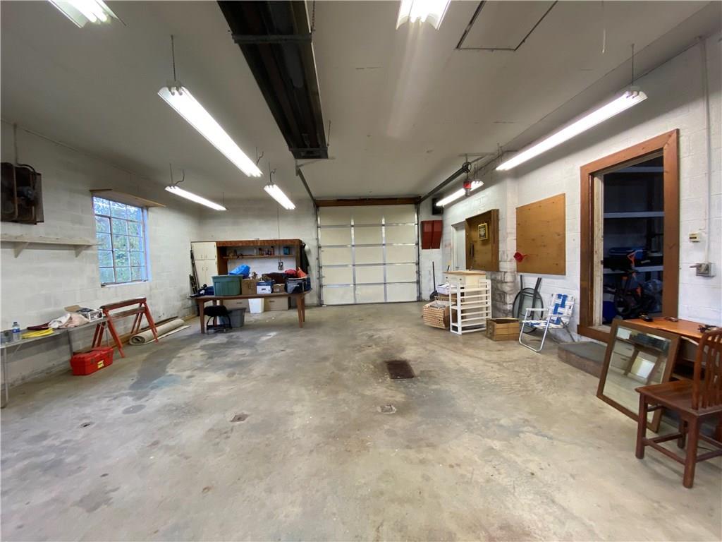 322 Thompson Run Road Ellwood City, PA 16117 - Photo 23 of 25 This side of the garage offers a 10' stall door and a gas heater. SO MANY OPTIONS to utilize this space!! Sellers even hosted parties inside!