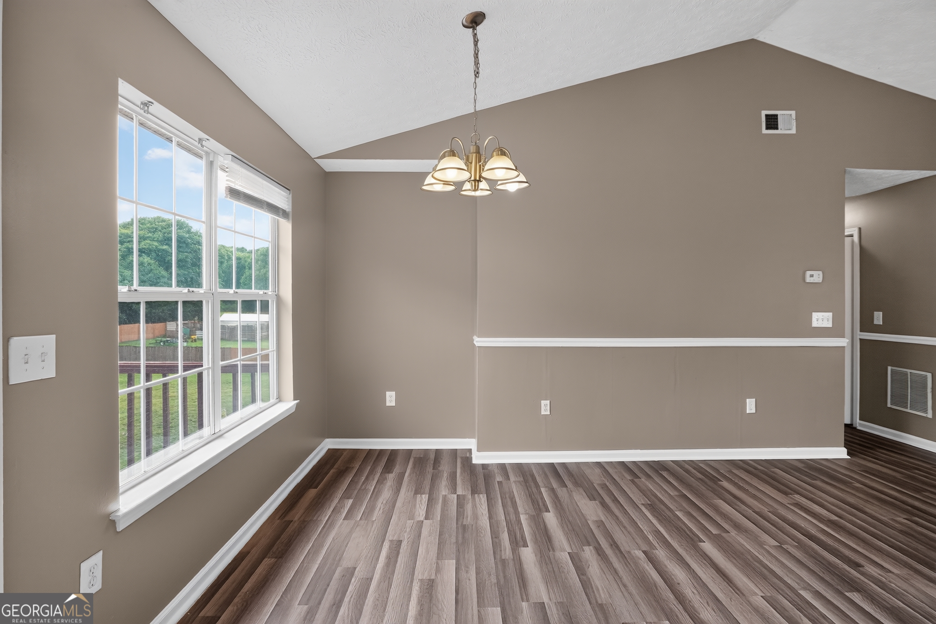75 Linsley Way Covington, GA 30016 - Photo 27 of 48 a view of a livingroom with a window and wooden floor