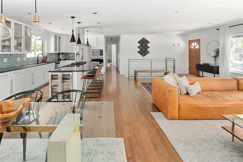 a living room with furniture and a kitchen view