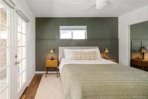 a large bed sitting in a bedroom next to a window