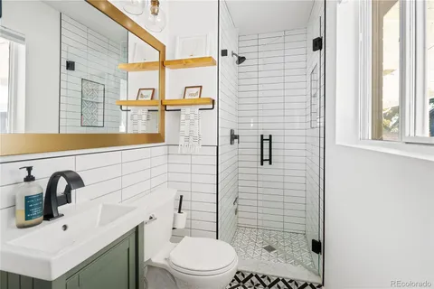a bathroom with a sink toilet and shower