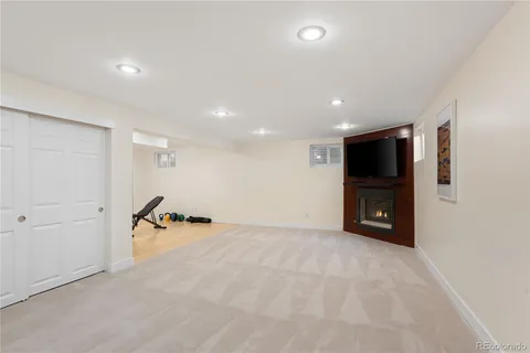 an empty room with furniture and a flat screen tv
