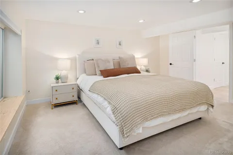 a spacious bedroom with a bed and a couch