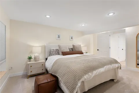 a bedroom with a bed and a night stand