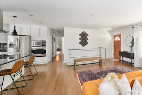 a living room with furniture a flat screen tv and a table