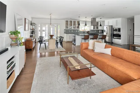 a living room with furniture and view of kitchen