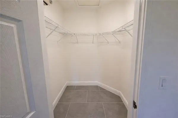 a kitchen with a sink and chairs