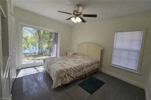 a view of an empty room with a fireplace and a window