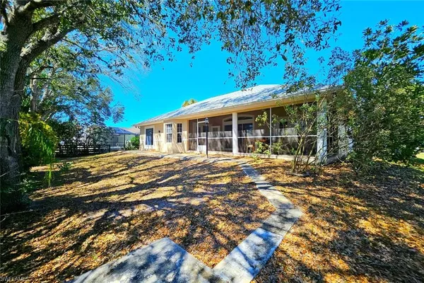 a view of a yard with plants and trees