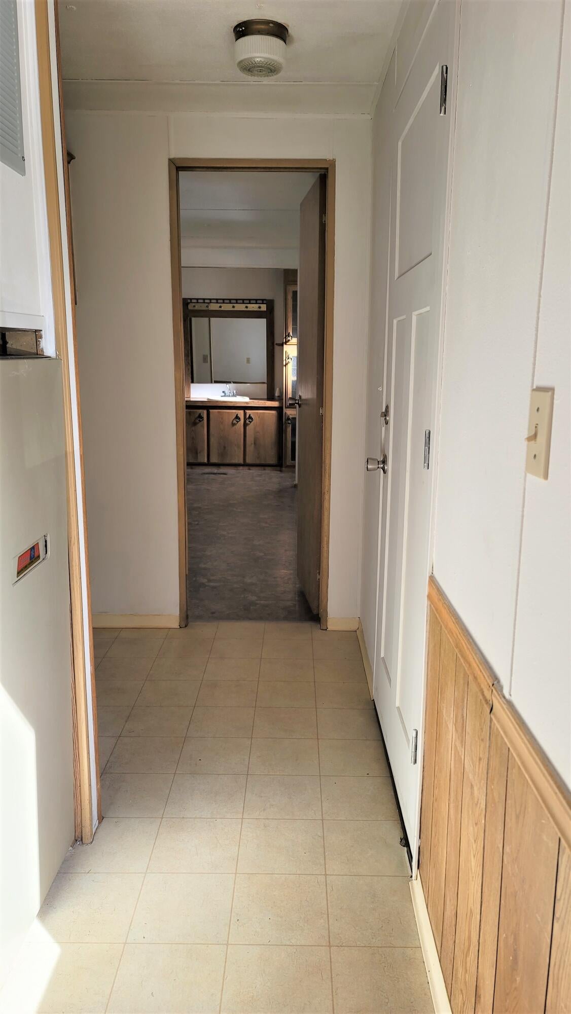 52731 Huntington Road, Unit 22 La Pine, OR 97739 - Photo 9 of 22 Hallway to primary bedroom. Back door exit to the right. Laundry area to the left.