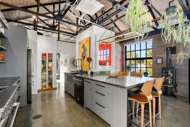 a kitchen with stainless steel appliances granite countertop a sink and cabinets
