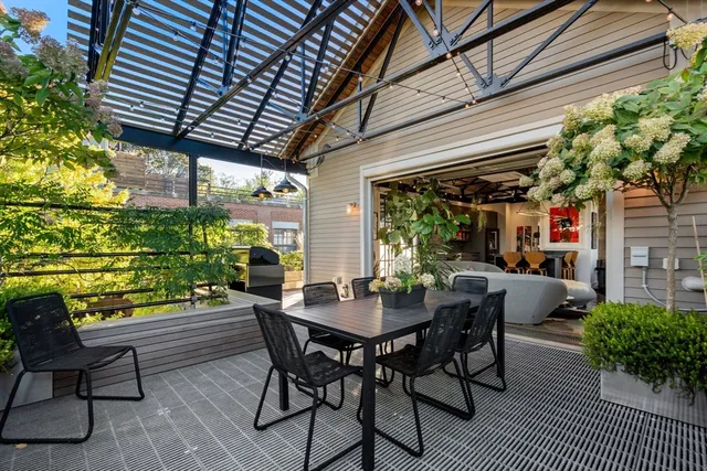 a dining room with furniture and a potted plant