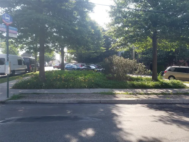 a backyard of a house with lots of green space and fountain