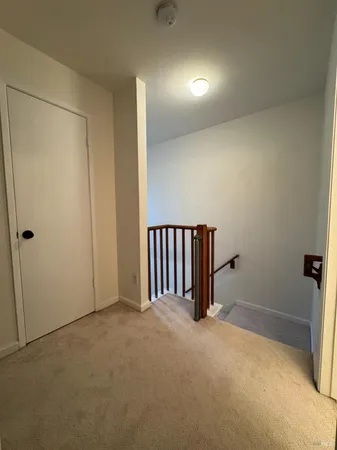 a bedroom with a bed flat screen tv and windows