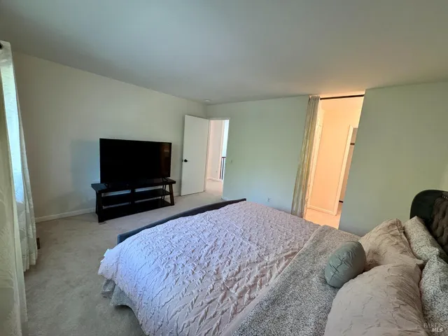 a spacious bathroom with a double vanity sink a toilet and a mirror