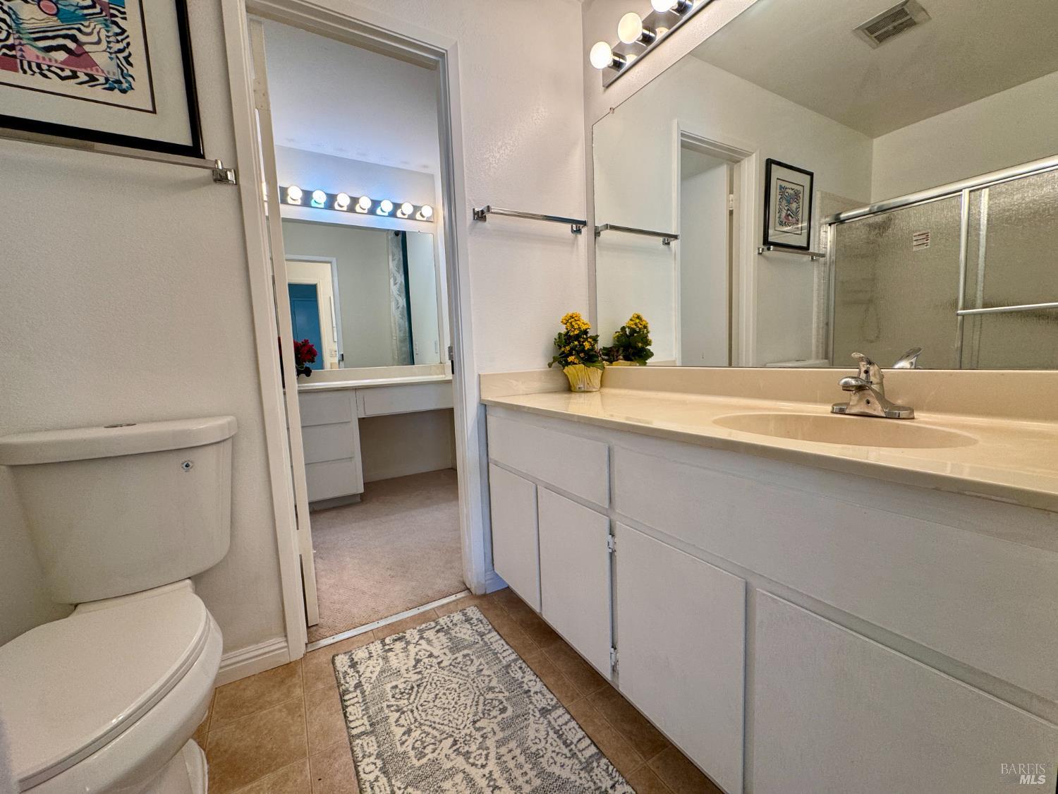58 Scottsdale Way Novato, CA 94947 - Photo 39 of 64 a spacious bathroom with a toilet a sink and mirror
