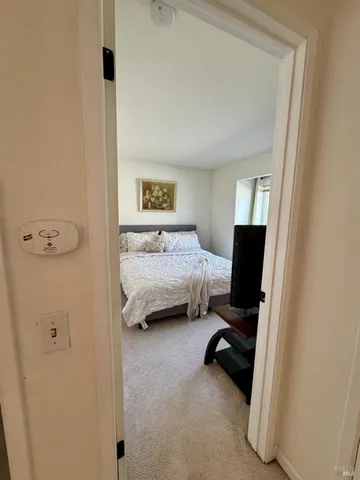 a bedroom with a bed and a television