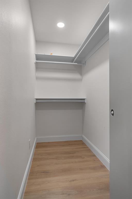 2108 Forest Hills Road Grapevine, TX 76051 - Photo 22 of 40 Recessed lighting, wood-finish flooring, and white shelving with hanging rods