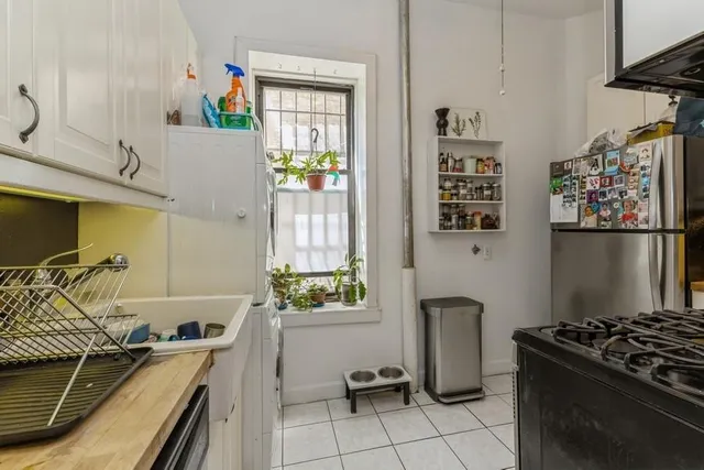 a kitchen with stainless steel appliances granite countertop a stove and a refrigerator