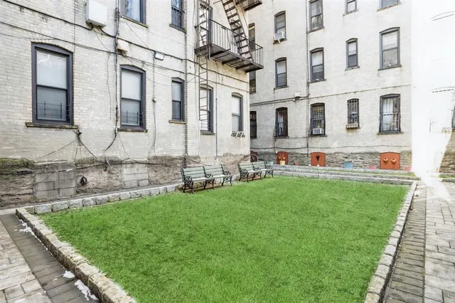 a view of a building with a yard