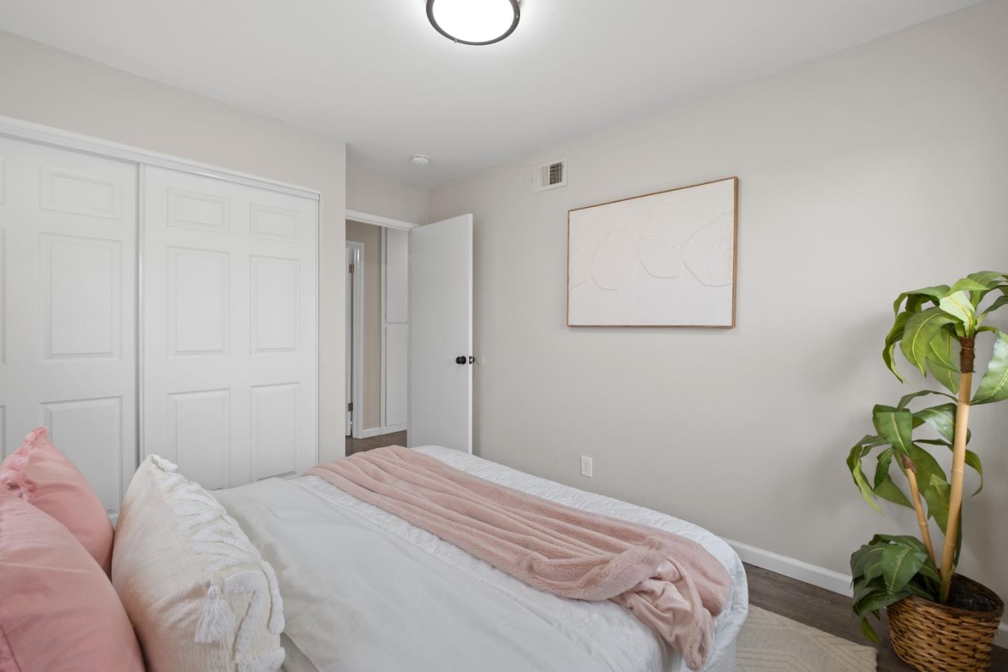 1732 Fallbrook Avenue San Jose, CA 95130 - Photo 39 of 54 a bedroom with a bed and a potted plant