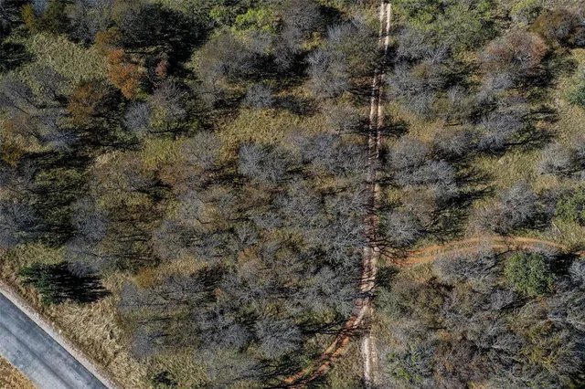 a view of a yard with wooden fence