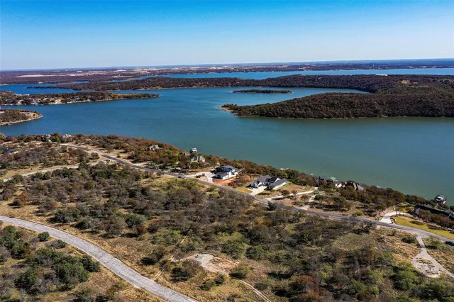 an aerial view of a house with a lake view