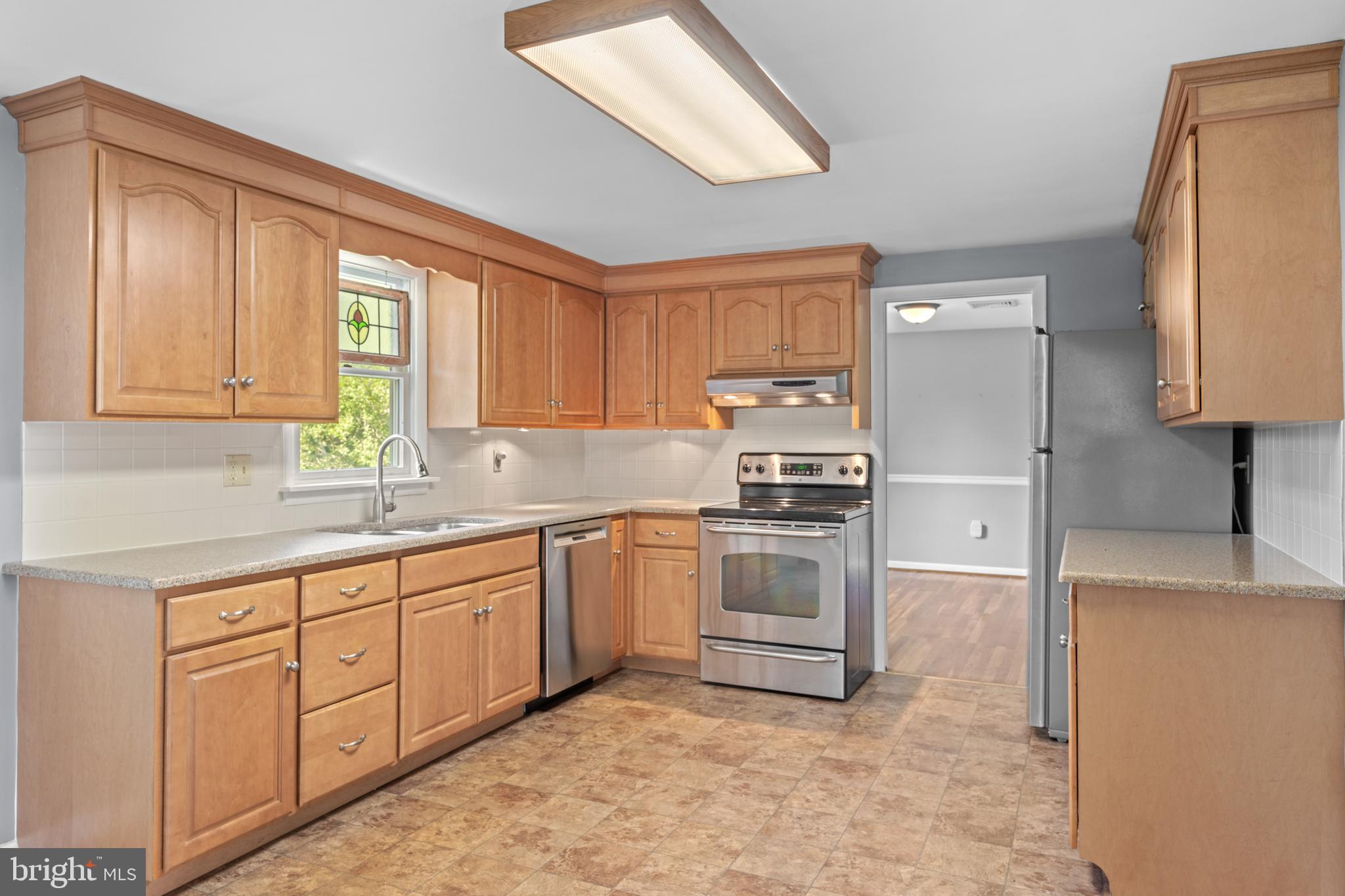 258 Monacy Road Coatesville, PA 19320 - Photo 22 of 54 a kitchen with granite countertop a sink stainless steel appliances and cabinets