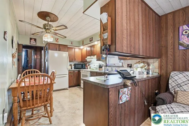 a kitchen with stainless steel appliances granite countertop a sink a stove and a refrigerator