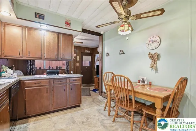 a kitchen with a dining table chairs and white cabinets