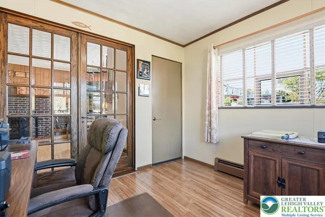 a view of a workspace with furniture and a window
