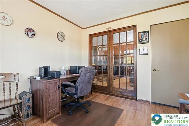a view of a workspace with furniture and a window