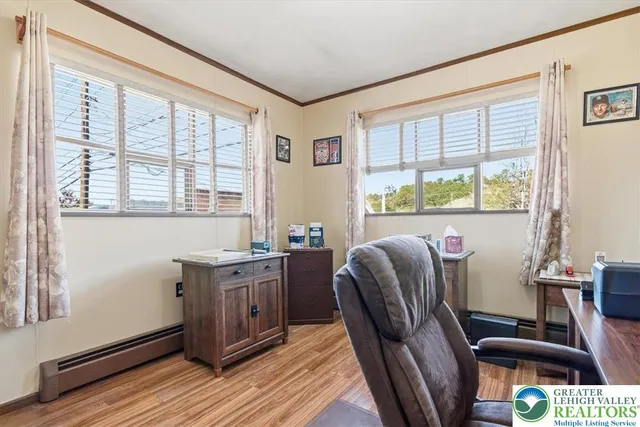 a view of a workspace with furniture and a window