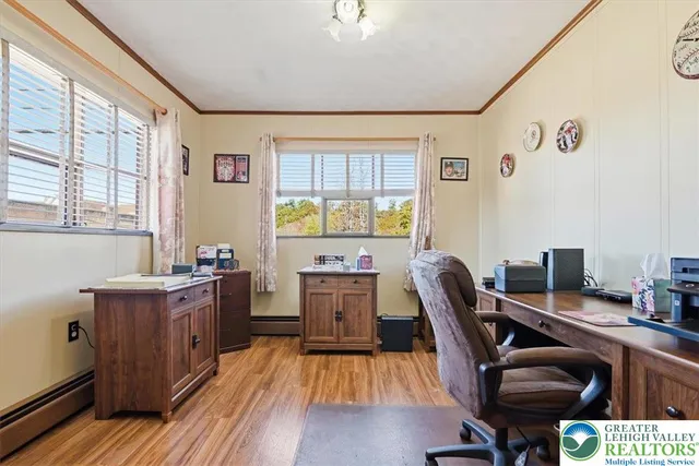 a view of a workspace with furniture and a window