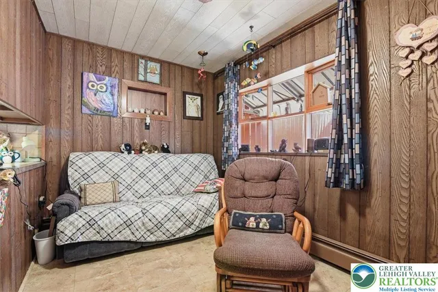 a bedroom with furniture and a large window